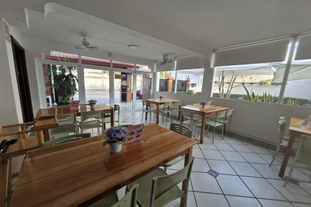instalaciones de kass bakery con mesas de madera sillas limpio ordenado y un ambiente agradable